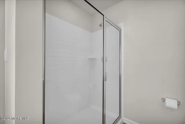 a bathroom with a glass shower door