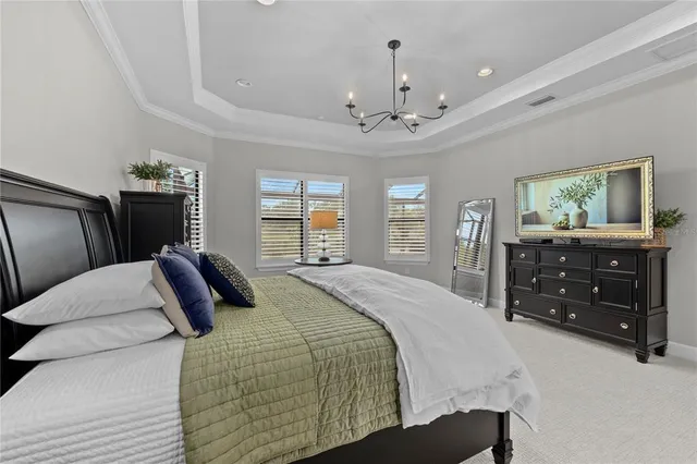 a bedroom with a large bed and a dresser