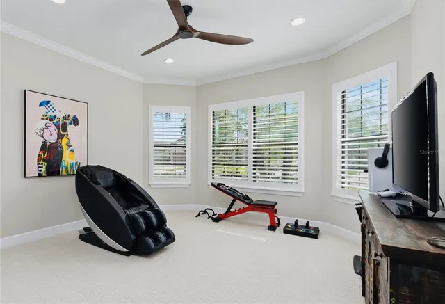 a bedroom with furniture and a flat screen tv