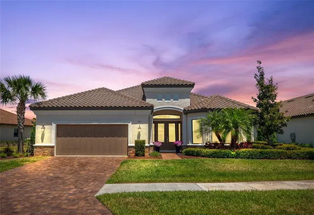a front view of a house with a yard and garage