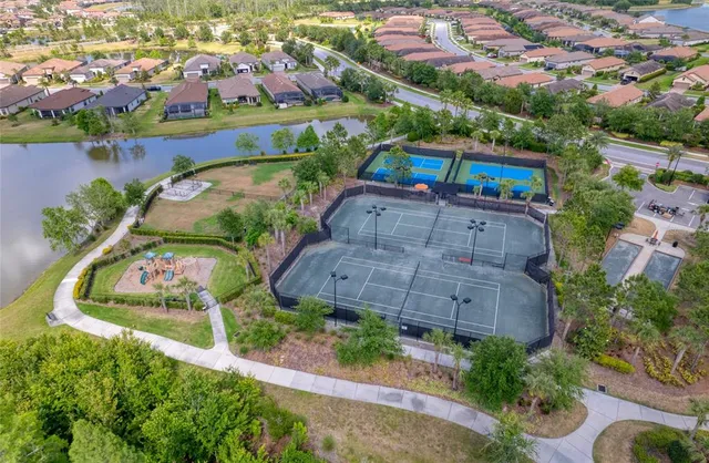 an aerial view of residential houses with outdoor space and swimming pool
