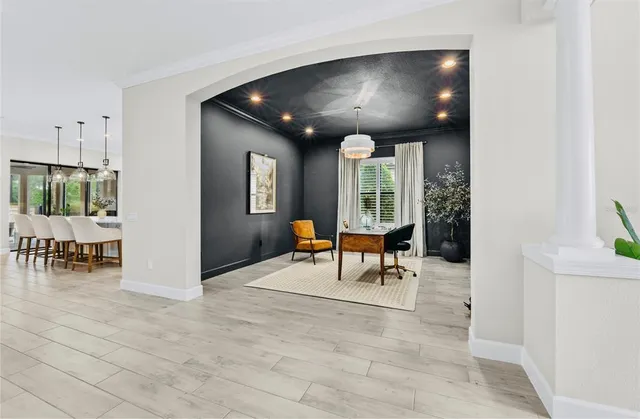a view of dining room with furniture and a chandelier