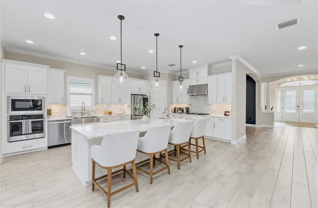 a large kitchen with a table and chairs