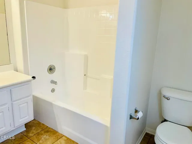 a bathroom with a bathtub and toilet
