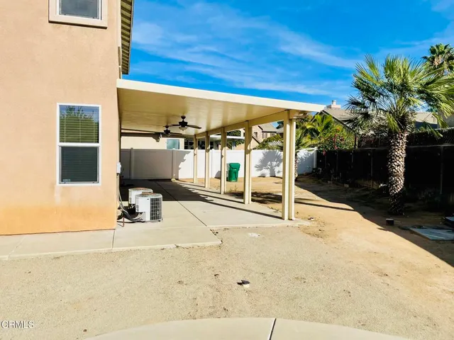 a view of a patio with table and chairs potted plants with wooden fence