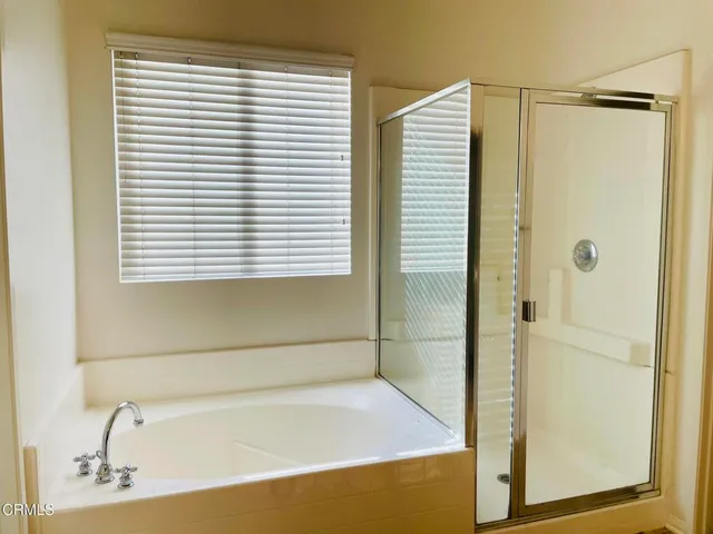 a bathroom with a bathtub and shower