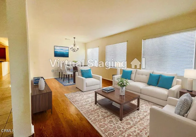 a living room with furniture wooden floor and a table