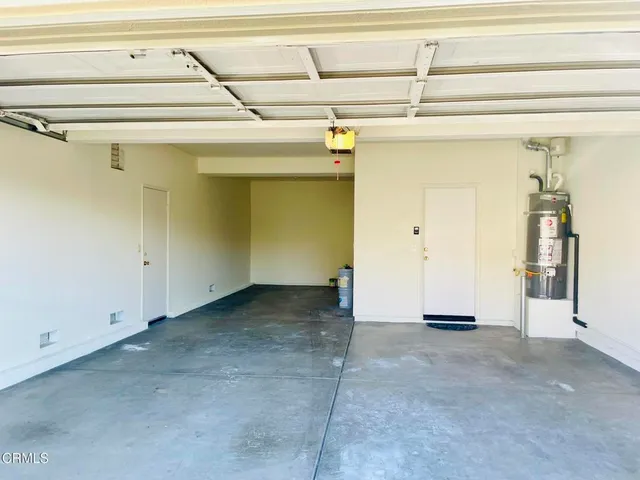 a view of a patio with table and chairs potted plants with wooden fence