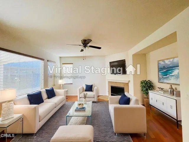 a living room with furniture fireplace and window
