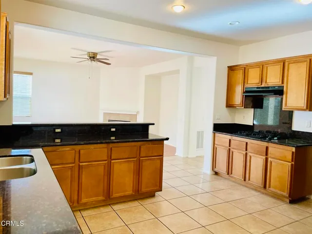 a kitchen with granite countertop a sink and a stove
