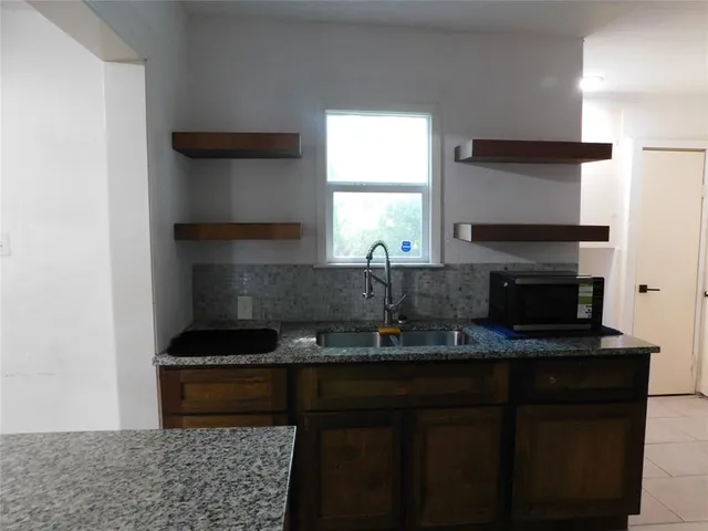 a kitchen with a sink and a stove top oven