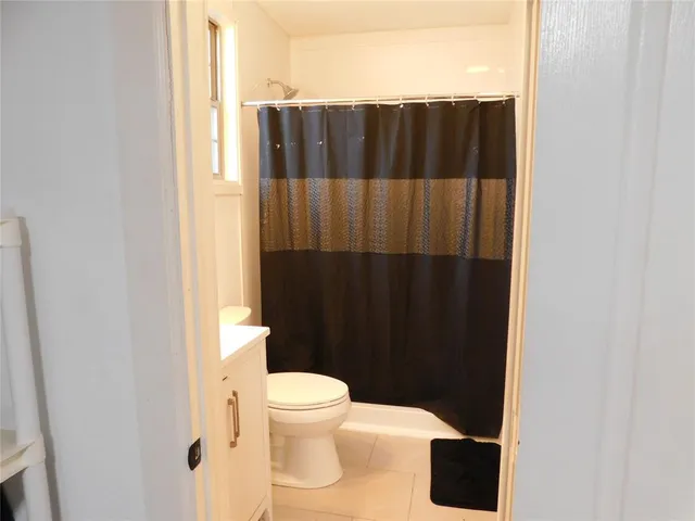 a bathroom with a shower and a toilet