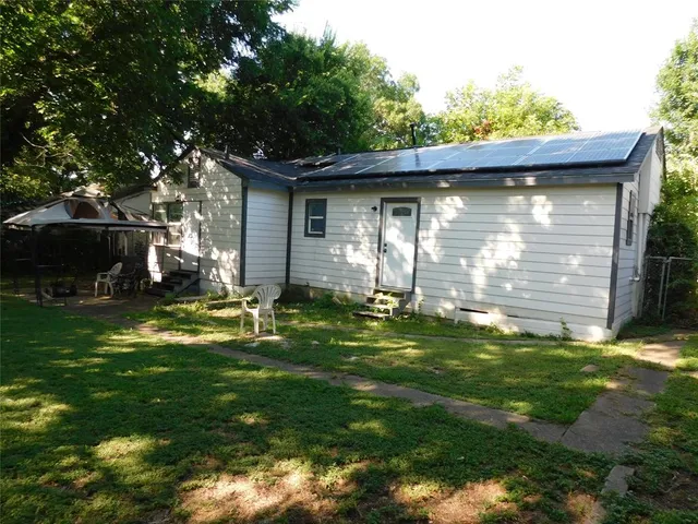 a backyard of a house with yard and outdoor seating
