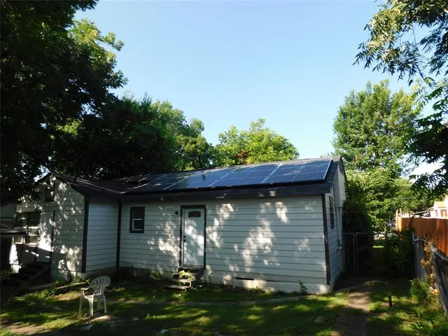 a view of a wooden house with a yard