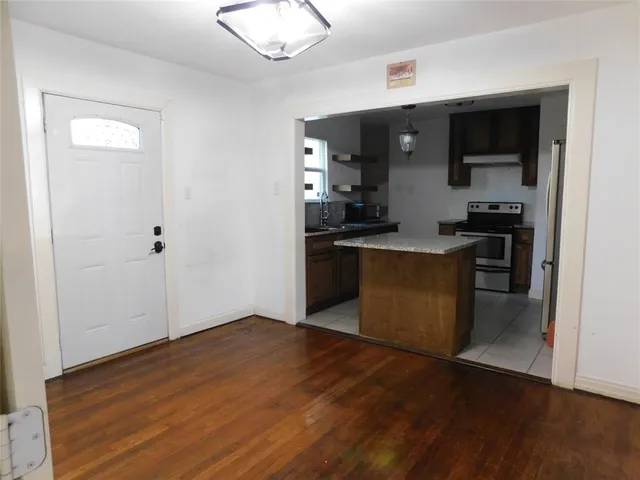 a kitchen with stainless steel appliances granite countertop a refrigerator and a stove top oven