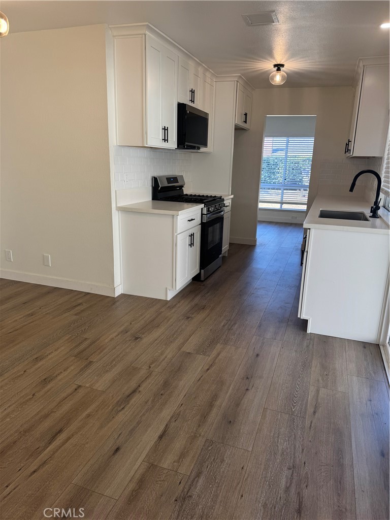 20157 Mckay Drive Walnut, CA 91789 - Photo 6 of 15 a kitchen with stainless steel appliances wooden floor and a sink