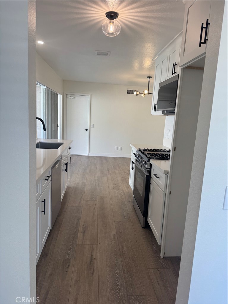 20157 Mckay Drive Walnut, CA 91789 - Photo 7 of 15 a kitchen with stainless steel appliances a sink a stove a refrigerator and cabinets