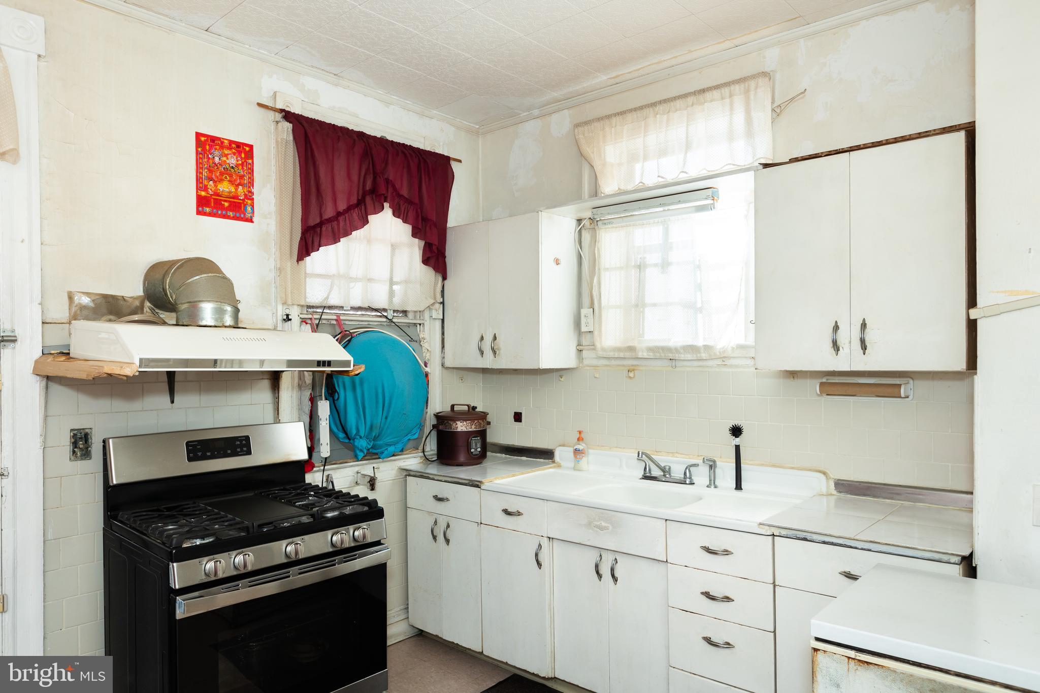 505 East 35th Street Baltimore, MD 21218 - Photo 12 of 45 a kitchen with stainless steel appliances a stove a sink and a refrigerator
