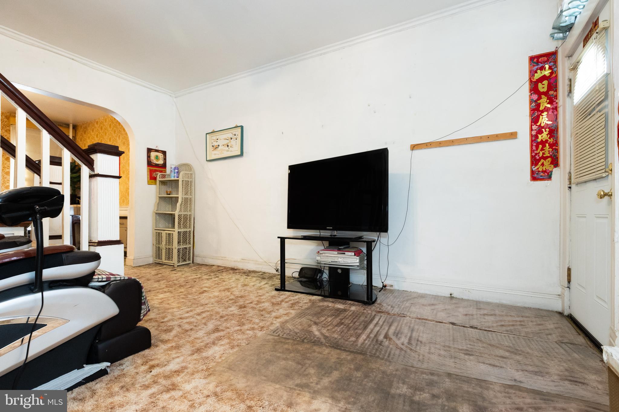 505 East 35th Street Baltimore, MD 21218 - Photo 16 of 45 a living room with furniture and a flat screen tv