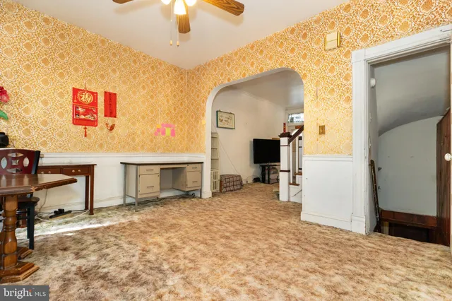 a view of a livingroom with furniture and staircase