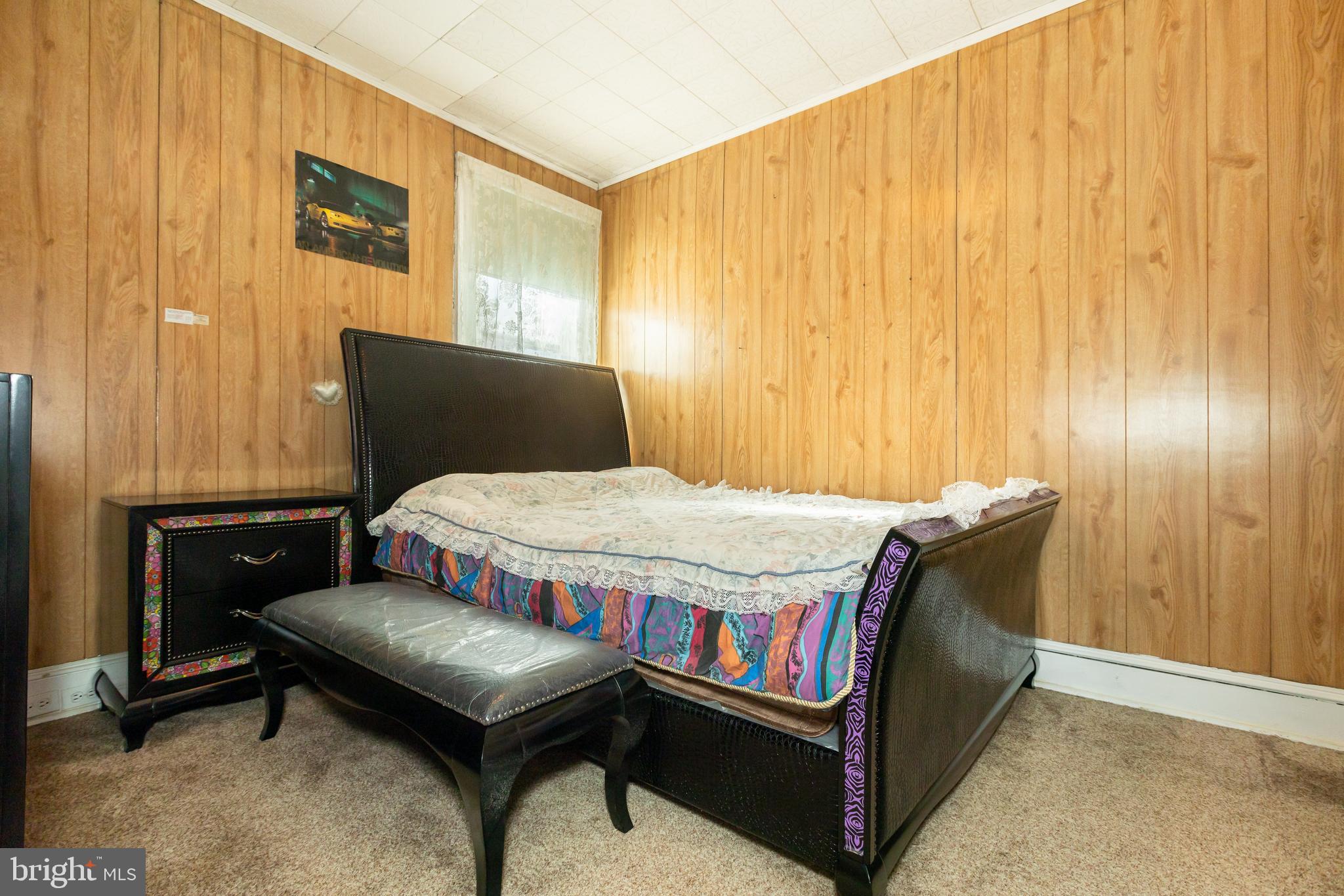 505 East 35th Street Baltimore, MD 21218 - Photo 32 of 45 a bedroom with a bed and a dresser