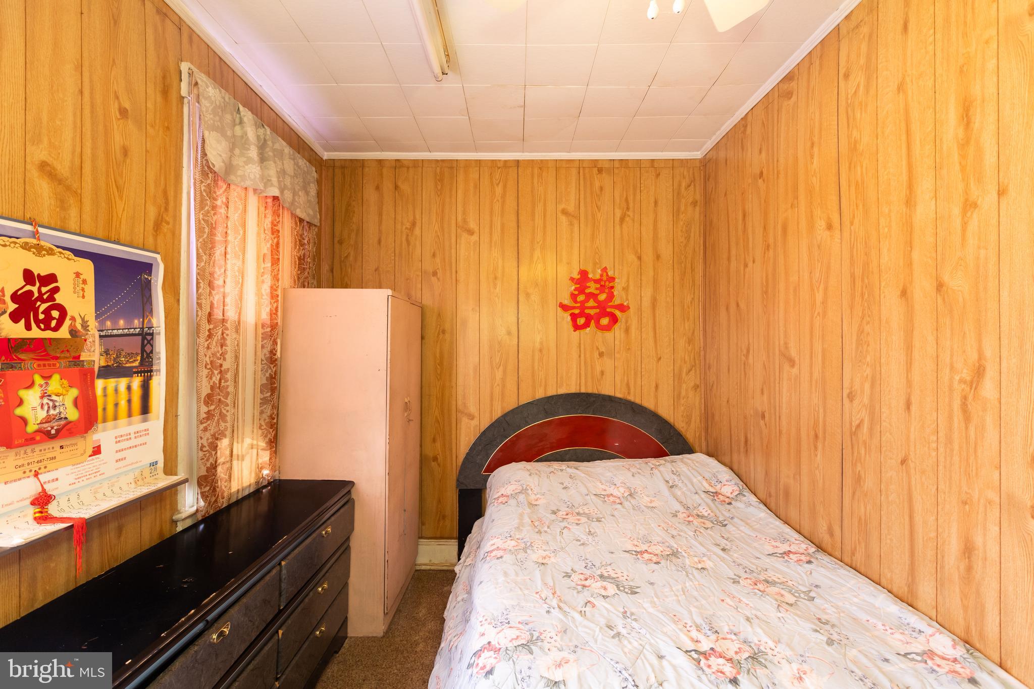 505 East 35th Street Baltimore, MD 21218 - Photo 33 of 45 a bedroom with a bed and a dresser