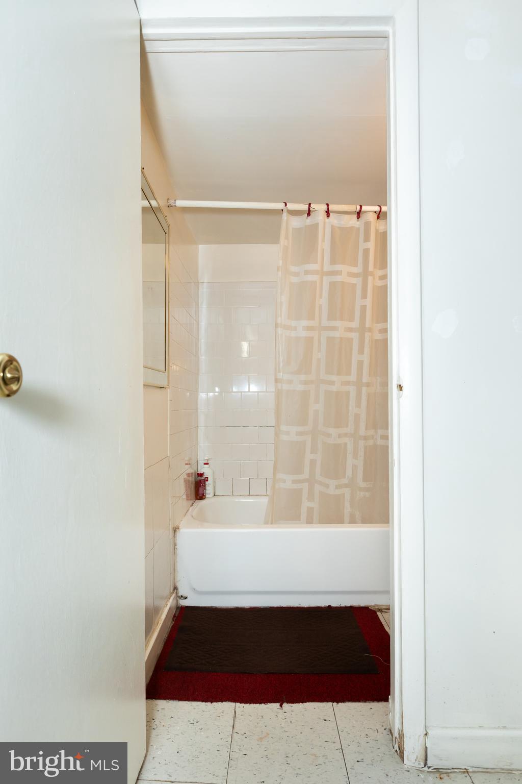 505 East 35th Street Baltimore, MD 21218 - Photo 37 of 45 a bathroom with a bathtub and shower