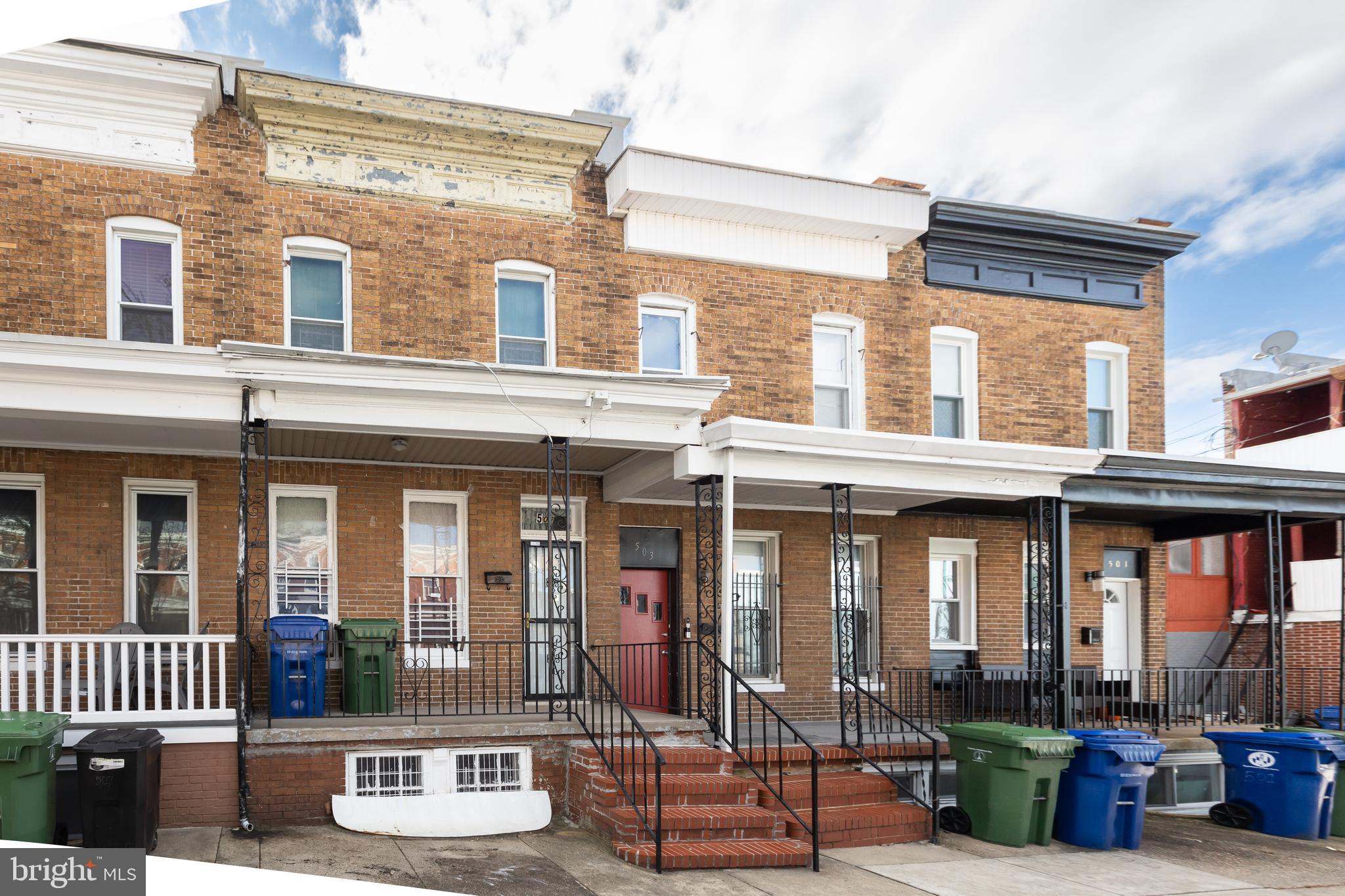 505 East 35th Street Baltimore, MD 21218 - Photo 5 of 45 front view of a brick building with a bench