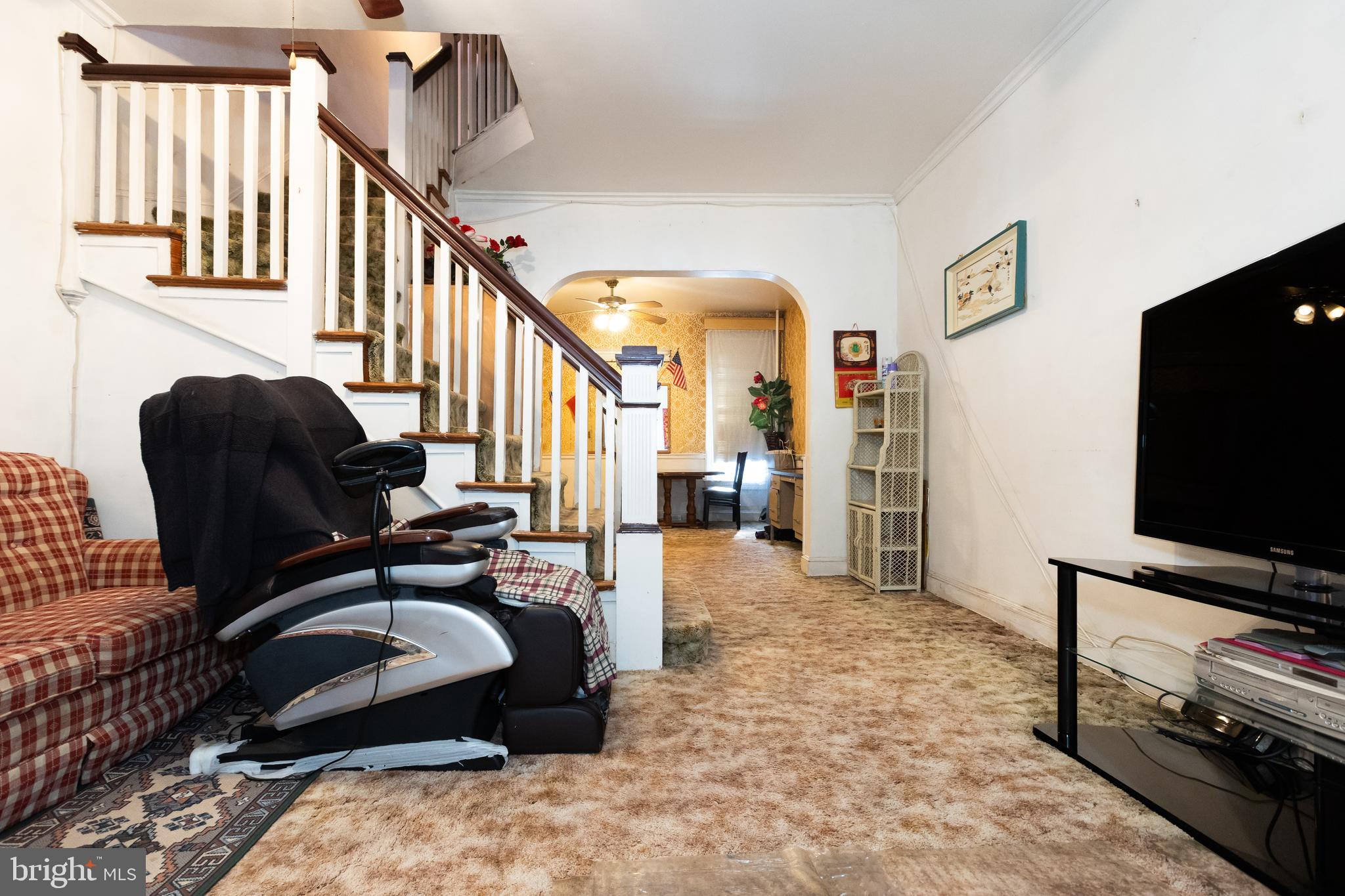 505 East 35th Street Baltimore, MD 21218 - Photo 10 of 45 a living room with furniture and a flat screen tv