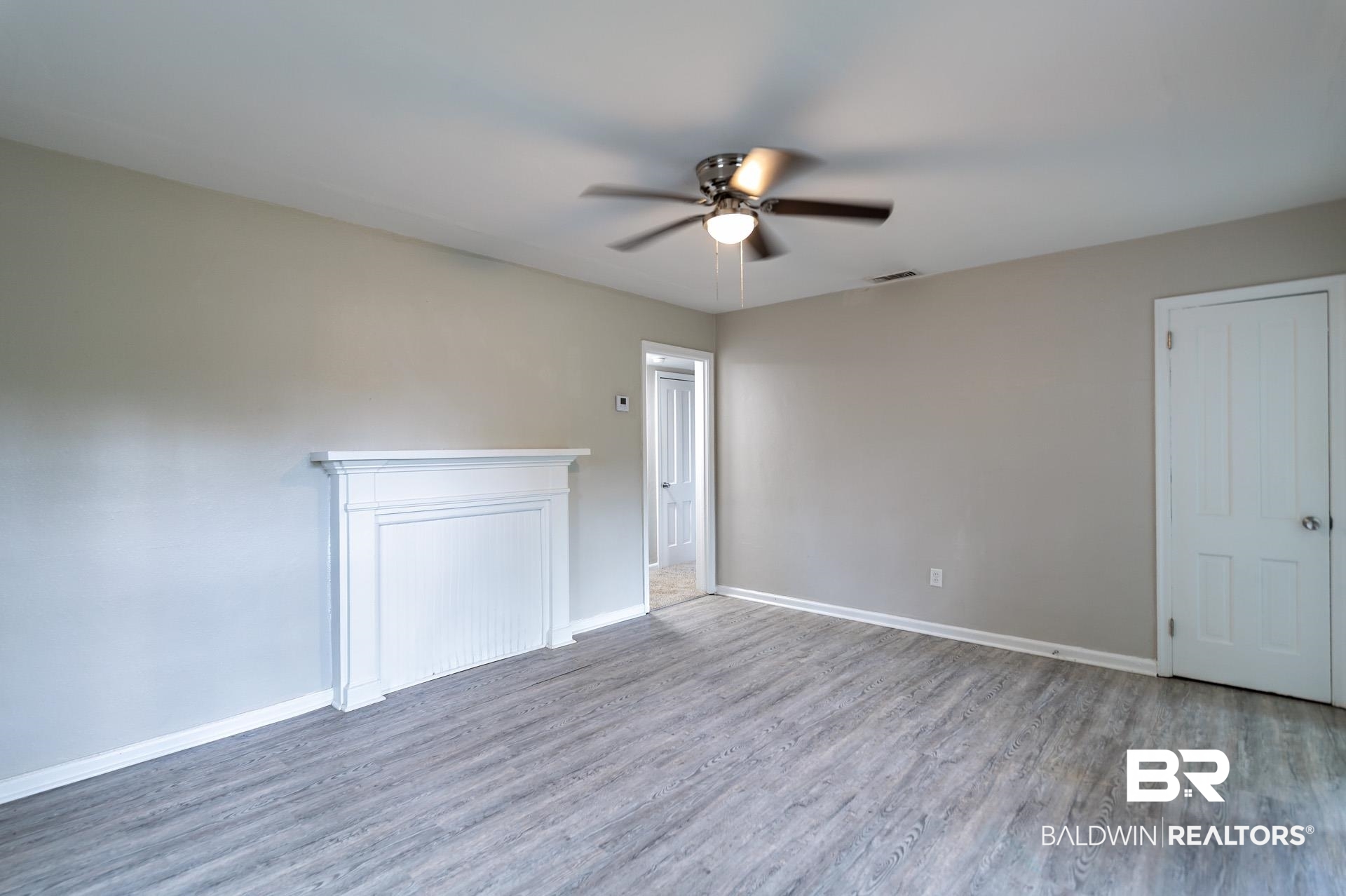 1869 Mott Drive West Mobile, AL 36617 - Photo 5 of 34 Empty room with wood finished floors, visible vents, baseboards, and ceiling fan