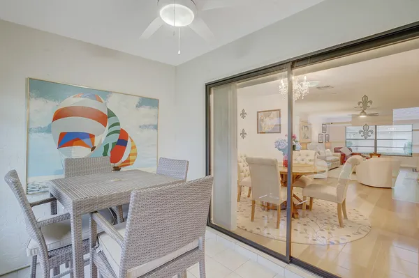 a view of a dining room with furniture and a floor to ceiling window