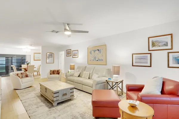 a living room with furniture a rug and a lamp