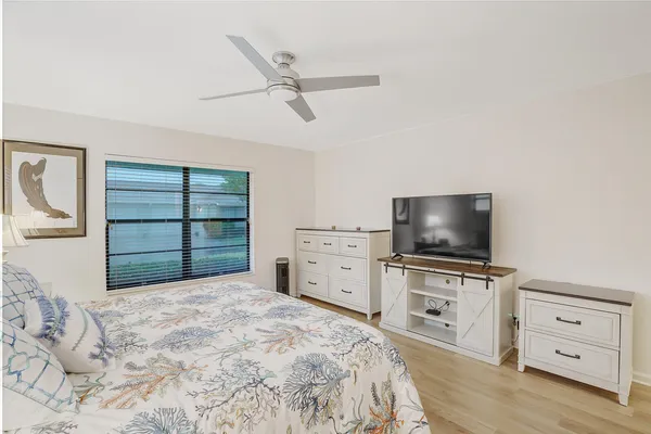 a bedroom with a bed and a flat tv screen in it