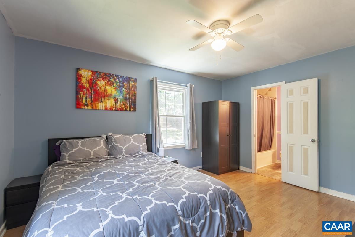 368 Minor Ridge Road Charlottesville, VA 22901 - Photo 12 of 29 a bedroom with a bed and a chandelier