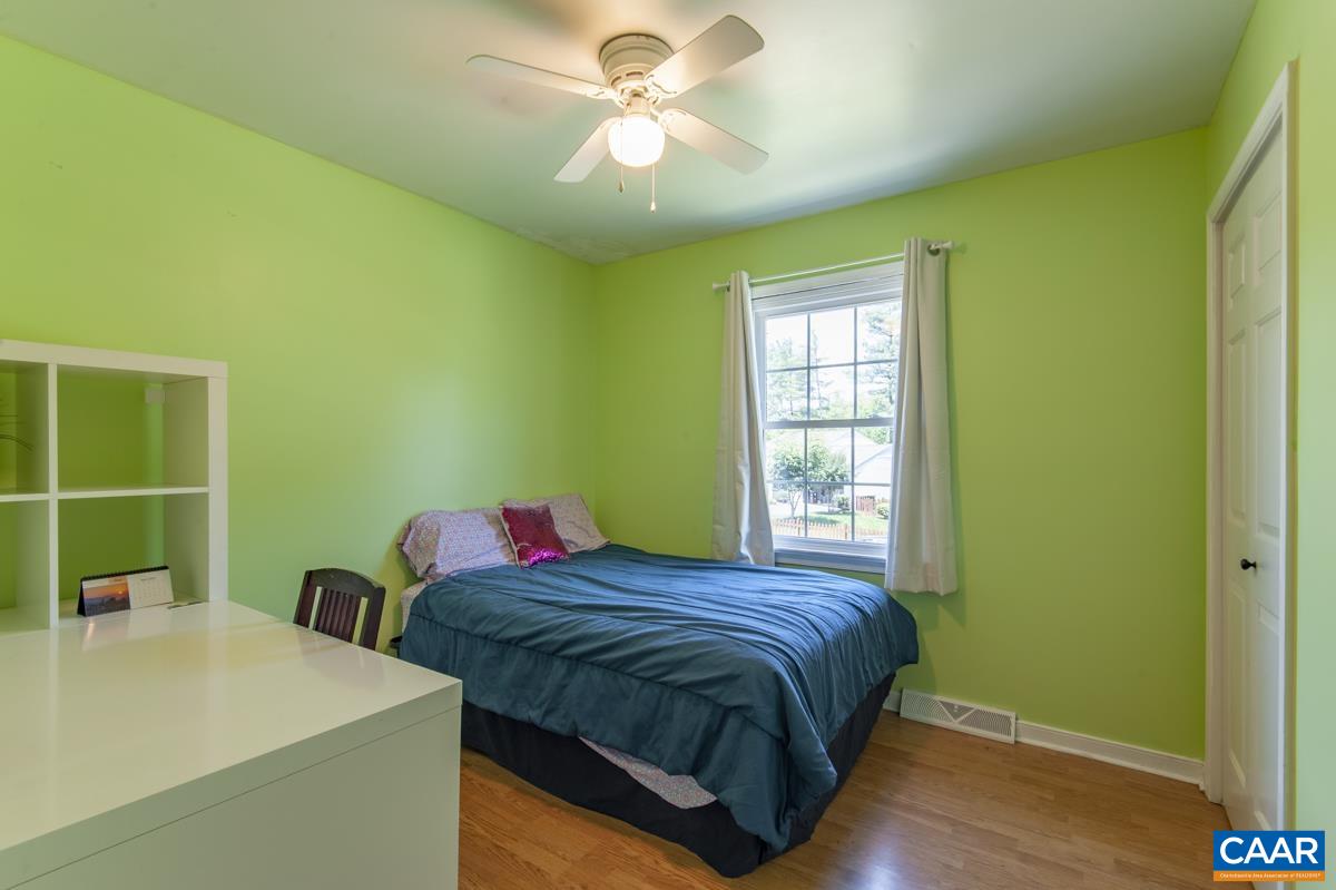 368 Minor Ridge Road Charlottesville, VA 22901 - Photo 15 of 29 a bedroom with a bed and a chandelier