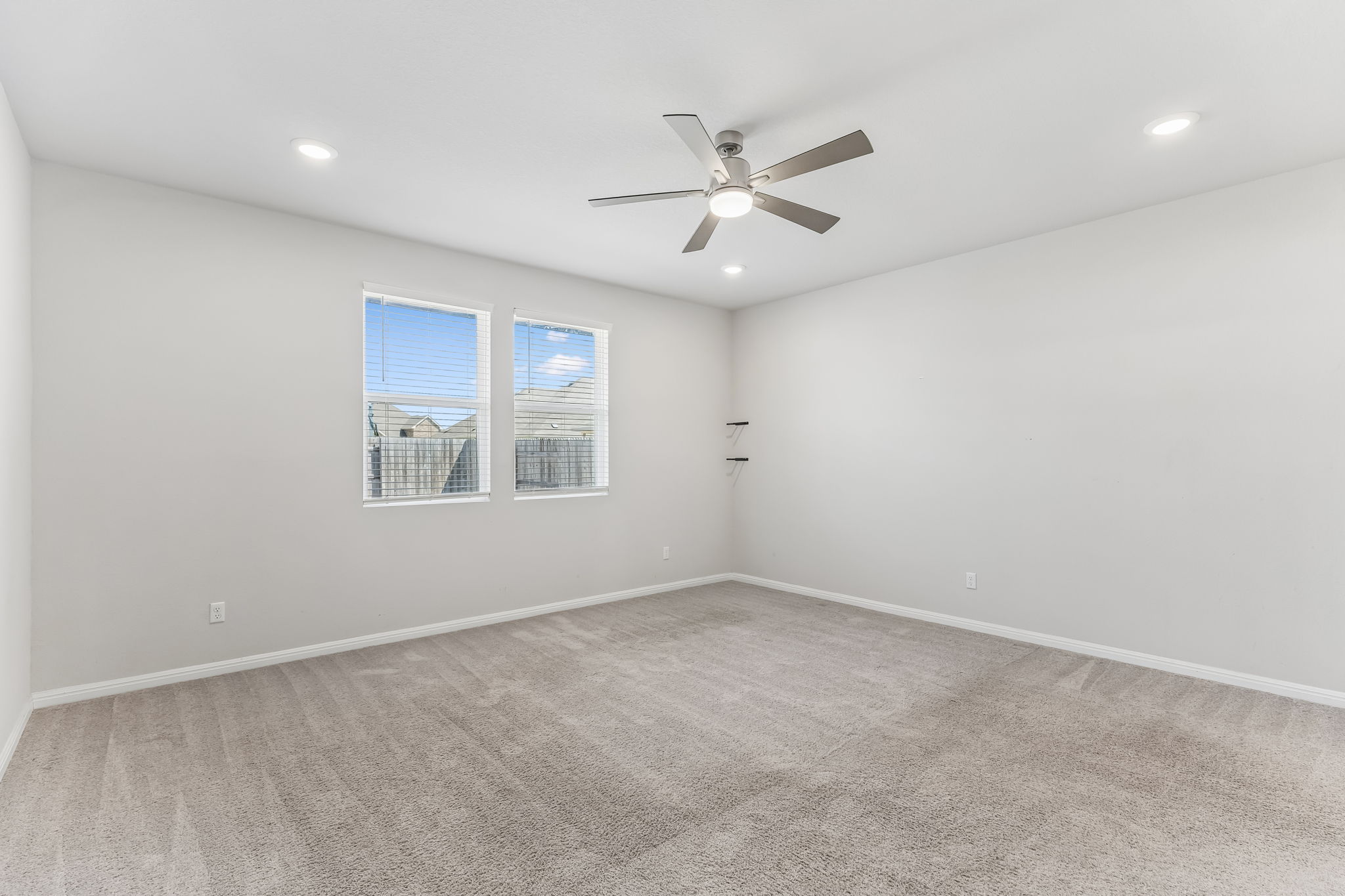 4009 Milano River Road Hutto, TX 78634 - Photo 19 of 40 Plush carpeting and recessed lighting create a comfortable atmosphere in this versatile room.