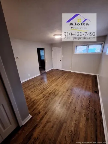 a view of an empty room and a window