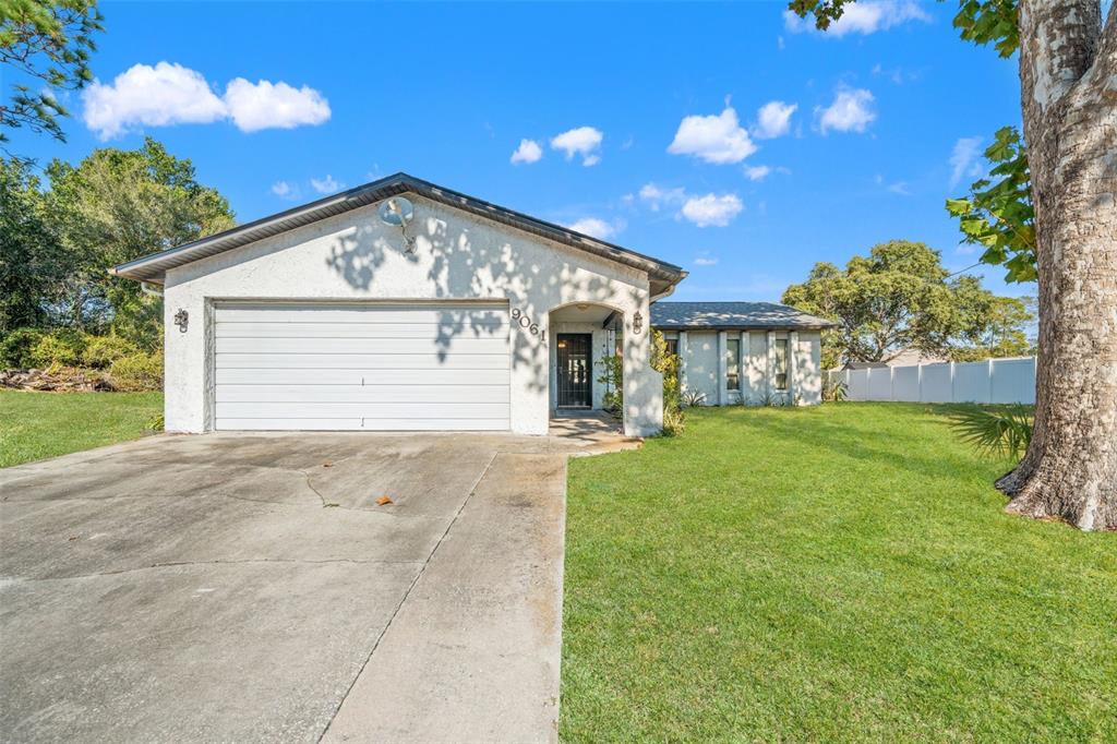 9061 Byron Street Spring Hill, FL 34606 - Photo 1 of 43 a view of a house with a backyard