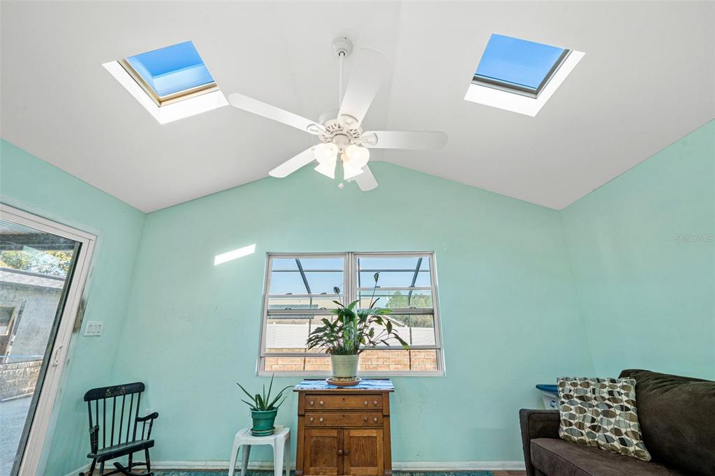 9061 Byron Street Spring Hill, FL 34606 - Photo 14 of 43 a living room with furniture and a chandelier