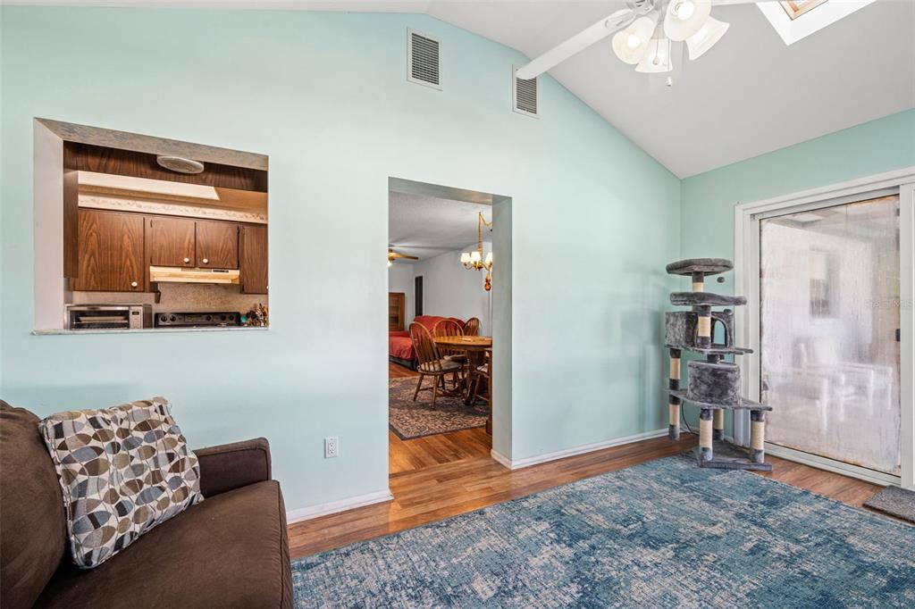 9061 Byron Street Spring Hill, FL 34606 - Photo 16 of 43 a living room with furniture and a flat screen tv