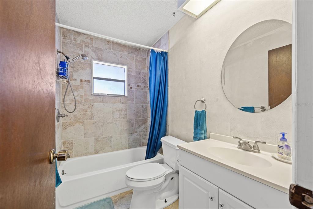 9061 Byron Street Spring Hill, FL 34606 - Photo 22 of 43 a bathroom with a sink toilet and shower