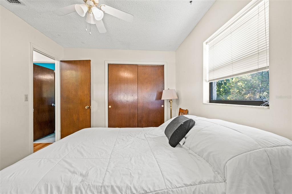 9061 Byron Street Spring Hill, FL 34606 - Photo 24 of 43 a bedroom with a bed and a chandelier