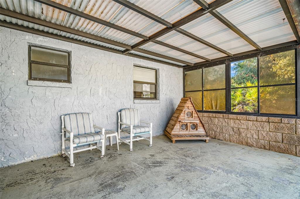 9061 Byron Street Spring Hill, FL 34606 - Photo 27 of 43 a view of an empty room with wooden floor and windows