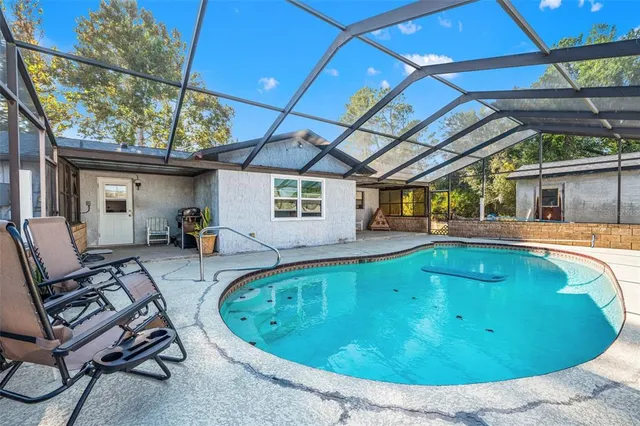 a view of a swimming pool with a patio