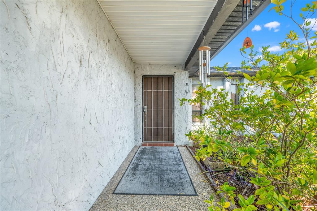 9061 Byron Street Spring Hill, FL 34606 - Photo 3 of 43 a view of a pathway with a flower garden