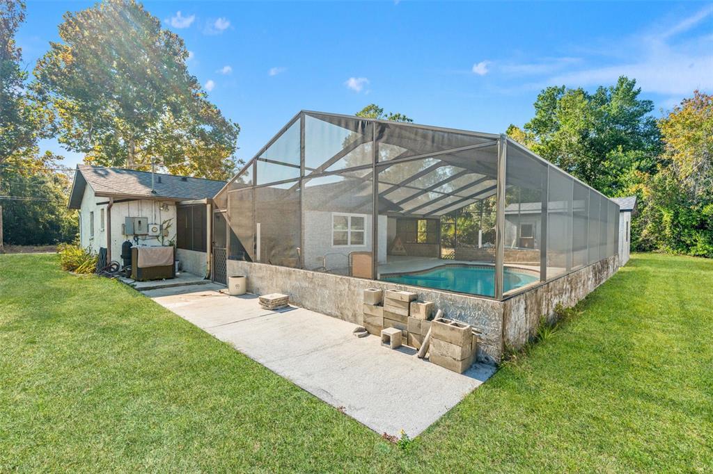 9061 Byron Street Spring Hill, FL 34606 - Photo 31 of 43 a view of a house with a yard and deck