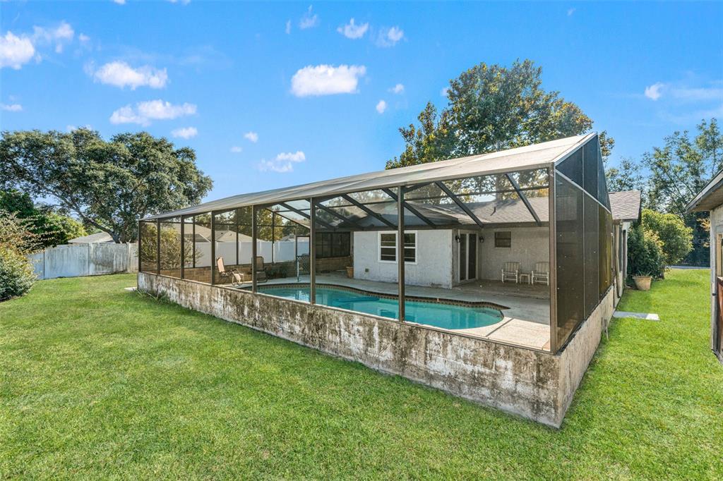 9061 Byron Street Spring Hill, FL 34606 - Photo 32 of 43 a view of house with a yard