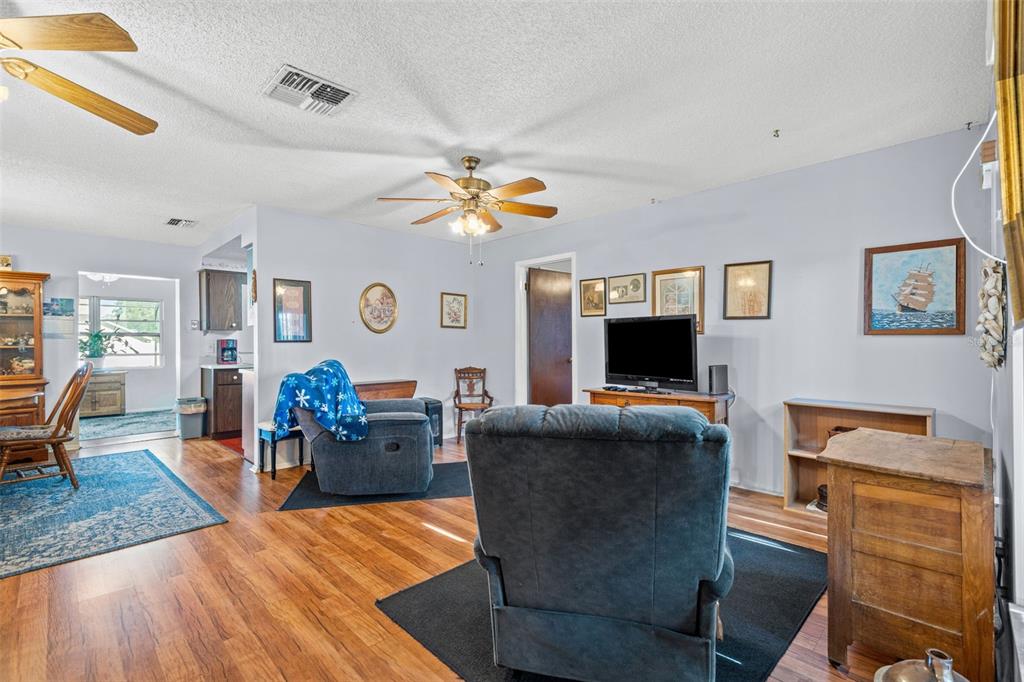 9061 Byron Street Spring Hill, FL 34606 - Photo 6 of 43 a living room with furniture and a flat screen tv