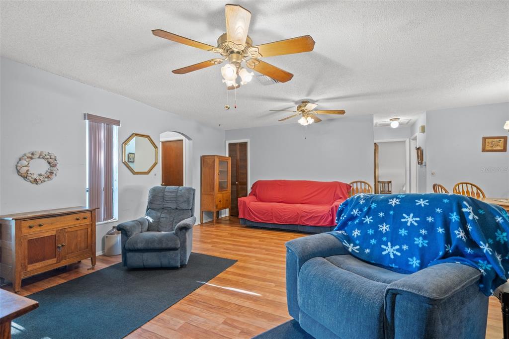 9061 Byron Street Spring Hill, FL 34606 - Photo 8 of 43 a living room with furniture and a chandelier
