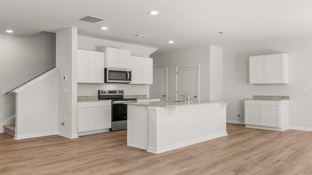 33 Rolling Mdw Trace Jasper, GA 30143 - Photo 4 of 38 a large kitchen with cabinets wooden floor and stainless steel appliances